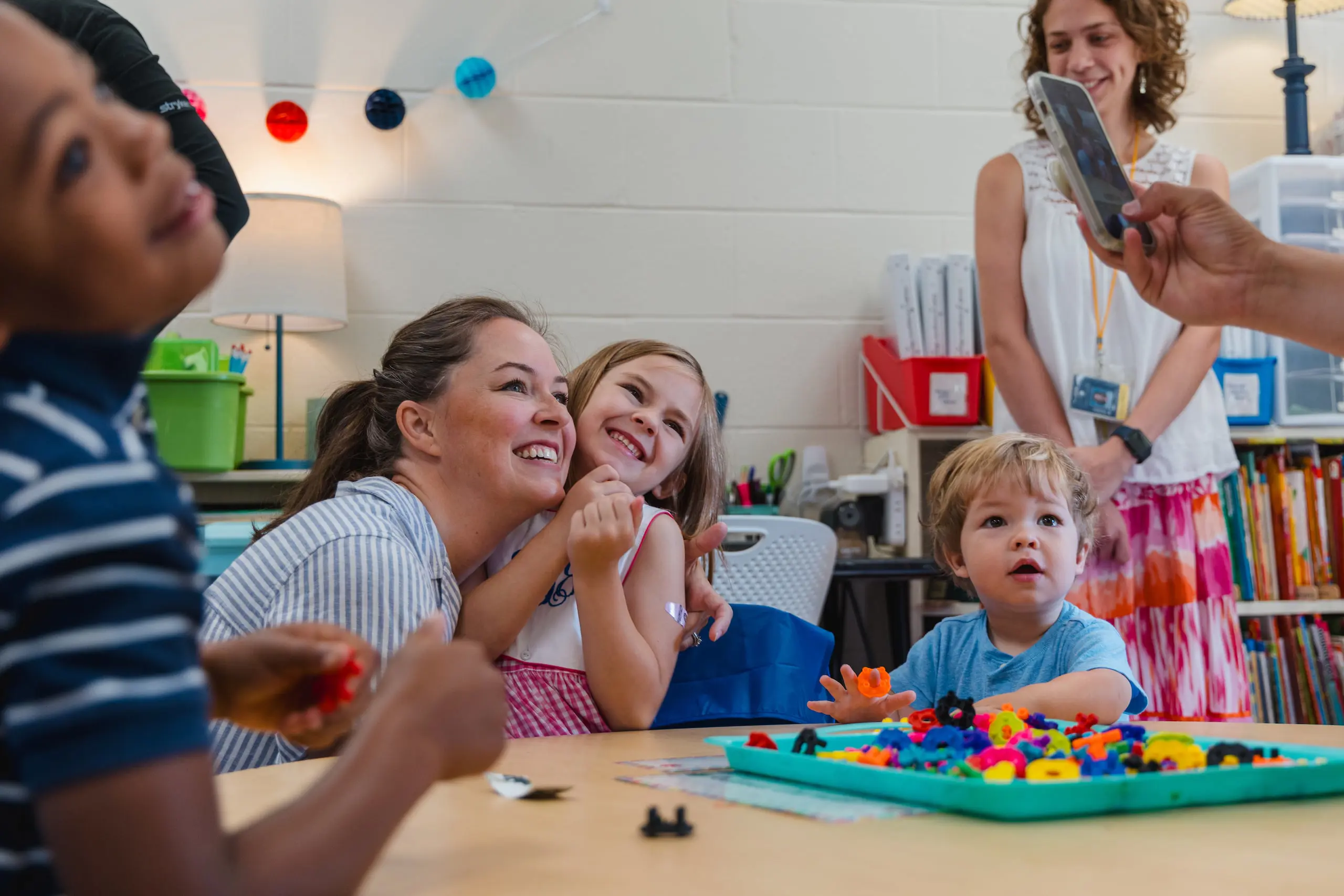 Young student with parent smiling at camera