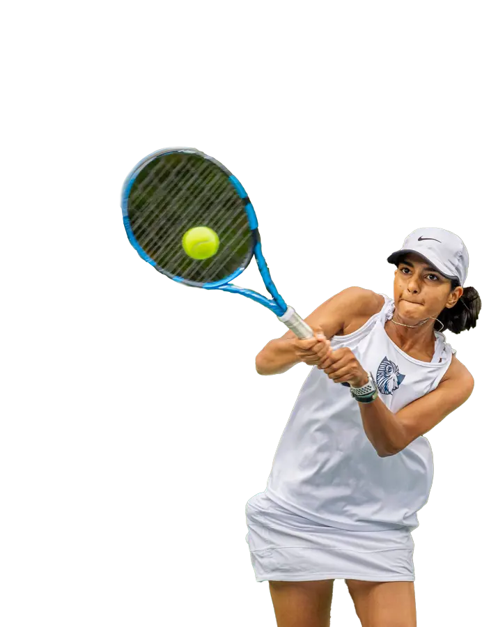 A focused female tennis player in white sportswear preparing to hit a tennis ball during a match.