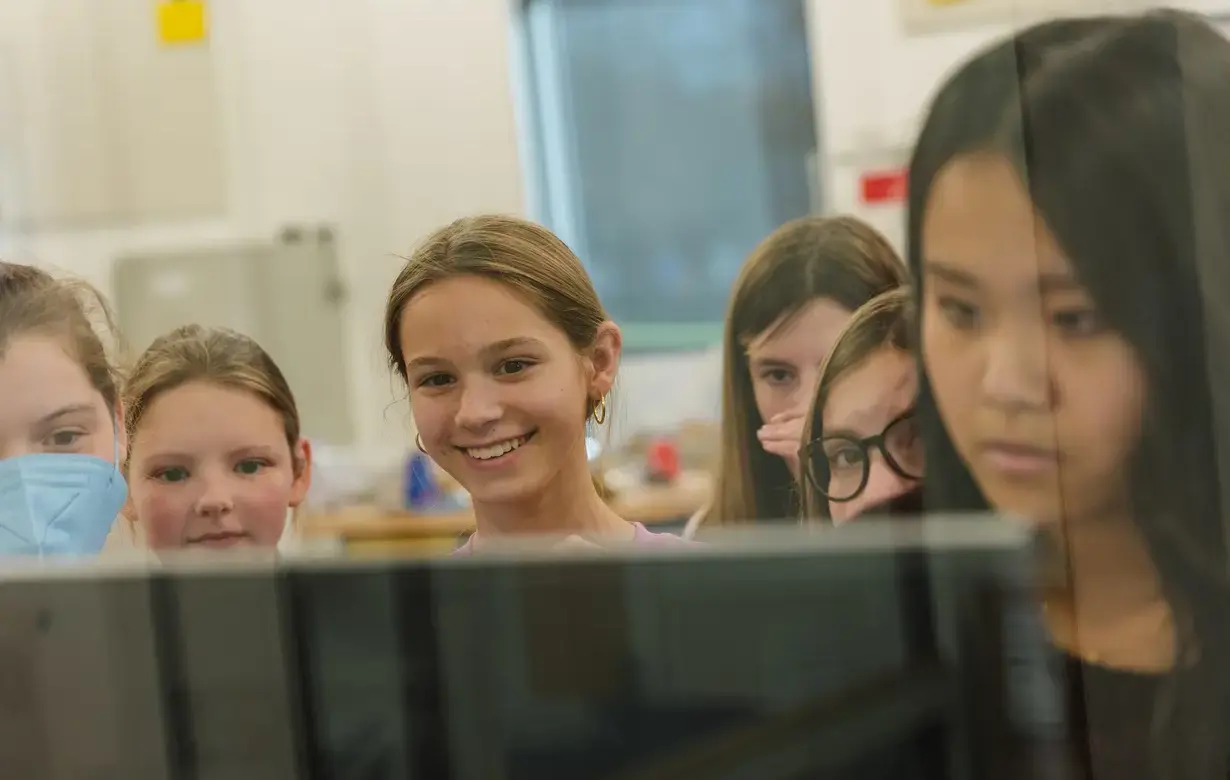 Group of Lower School students looking at computer screen