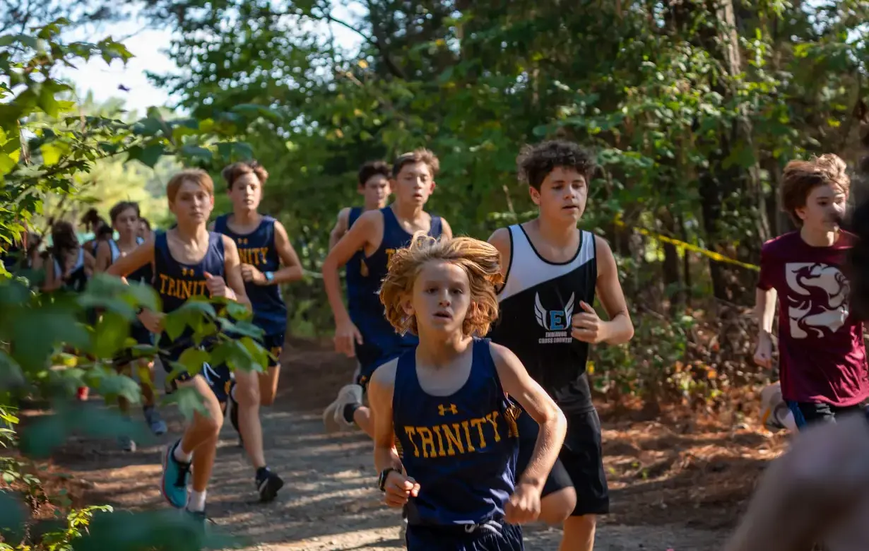 Group of Middle School male students running cross country