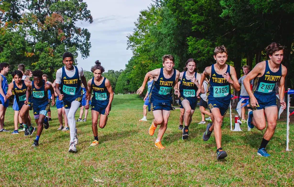 Group of male students running cross country