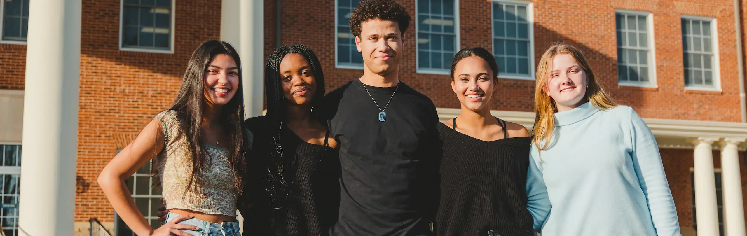 Group of students standing outside Trinity School building