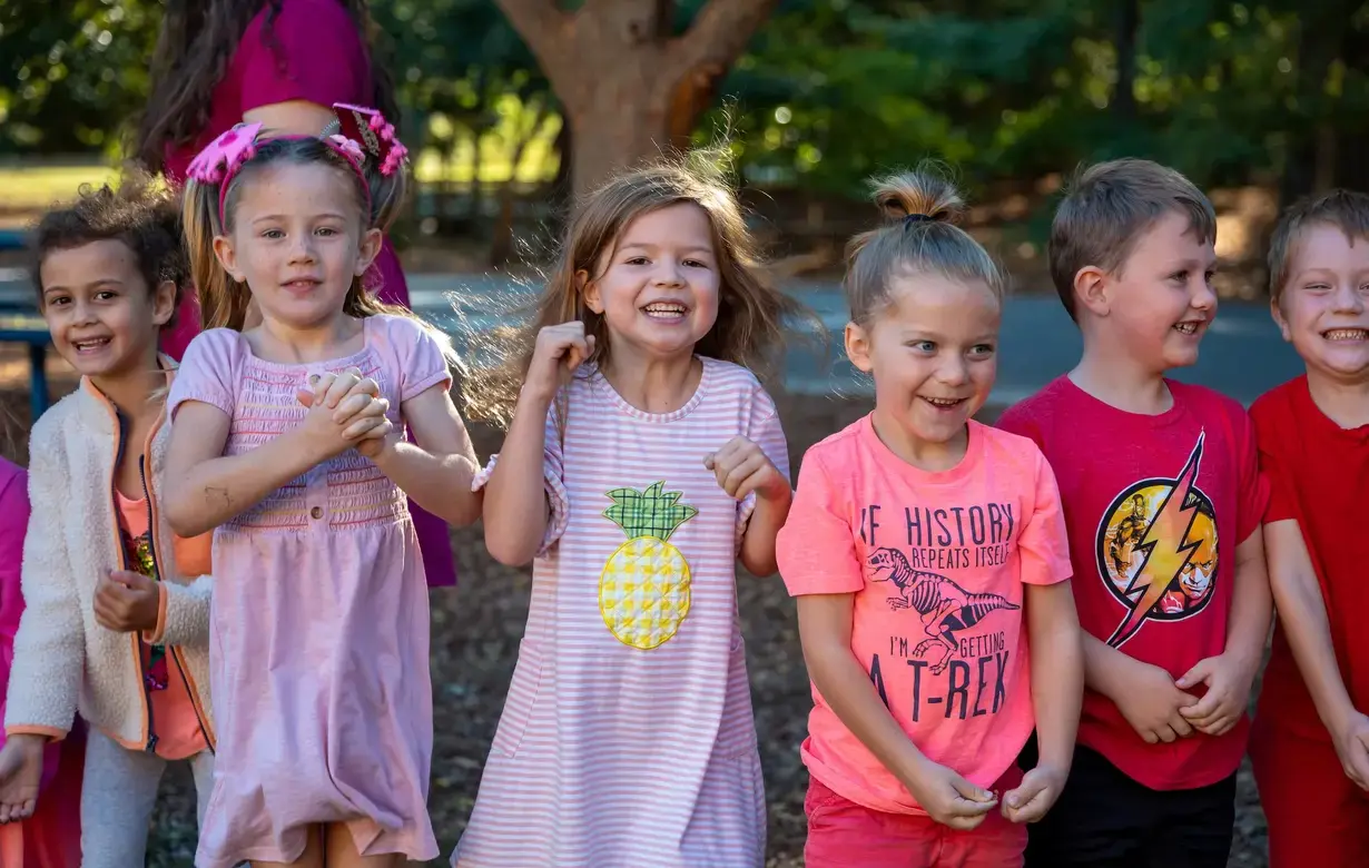 Group of young Trinity Lower School students outside smiling