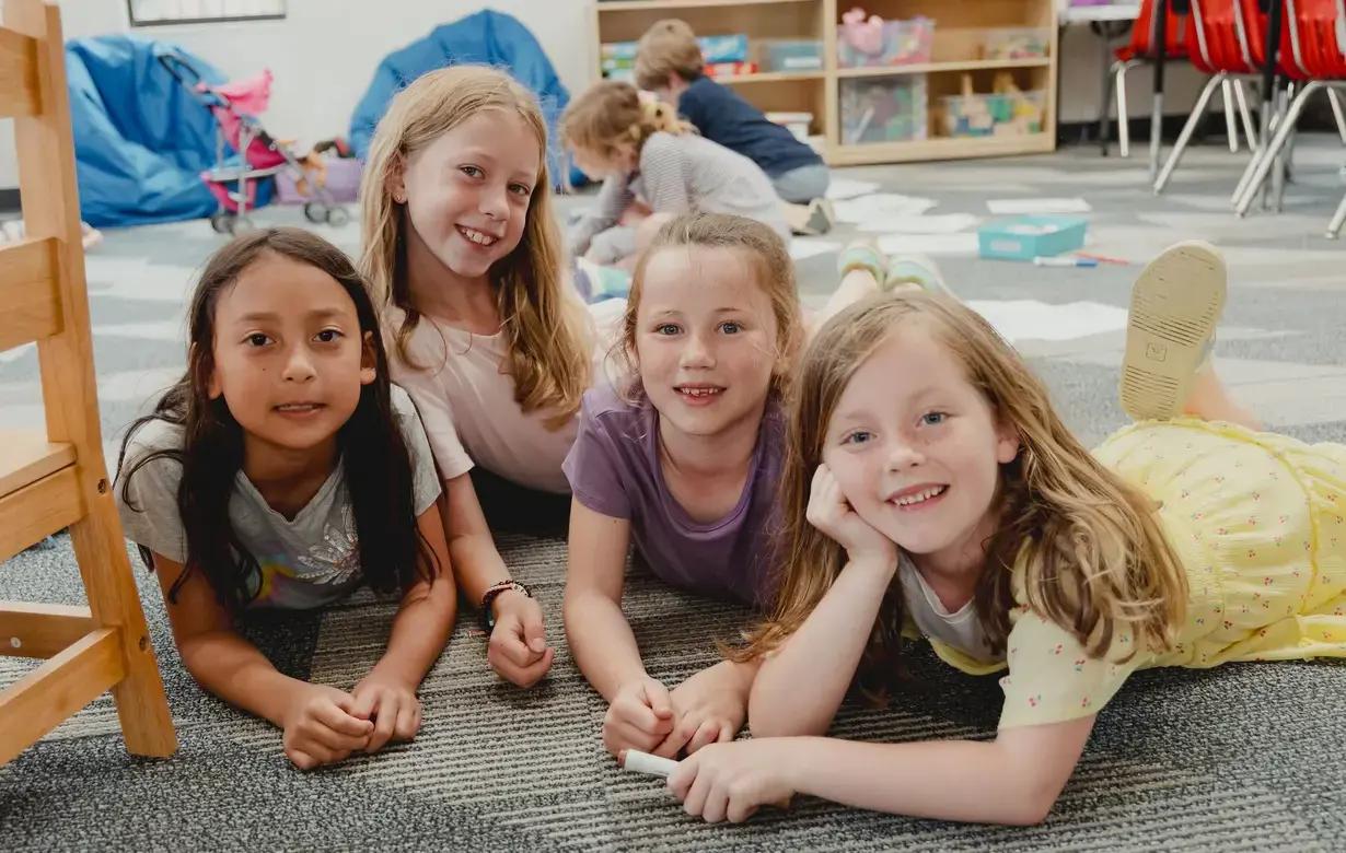 Group of Trinity Lower School students sitting on the floor during after school care