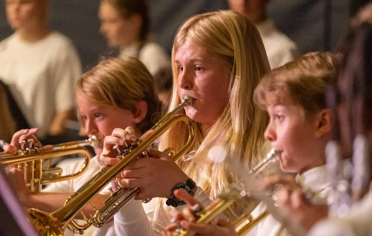 Trinity Lower School students playing trumpets