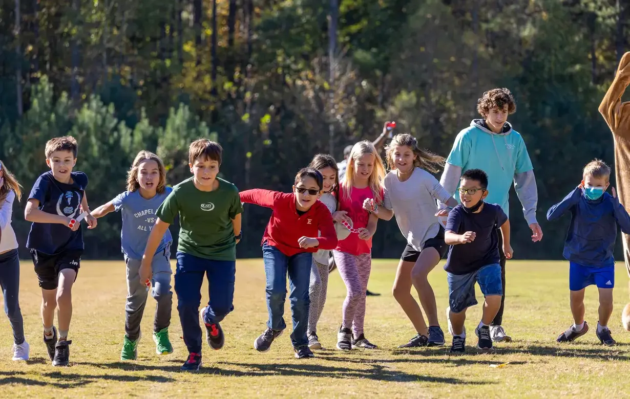 Group of Lower School Trinity students running race outside