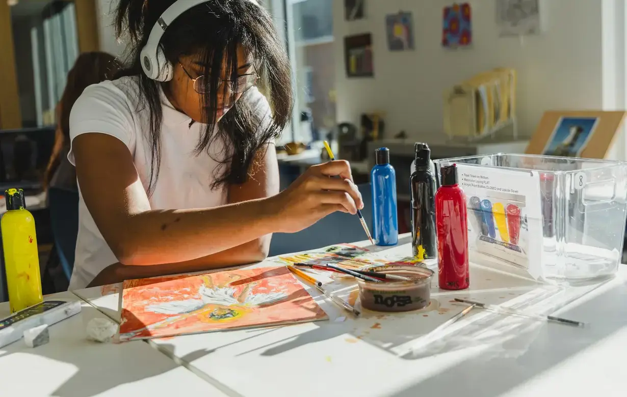 Student painting at desk