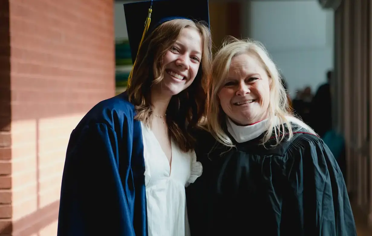 Student and faculty member at graduation